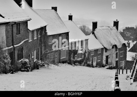 Winter on Gold Hill at Shaftesbury in Dorset depicting the famous row of traditional cottages situated on the cobbled slope Stock Photo