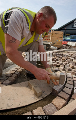 Modern cobblestone being laid Stock Photo