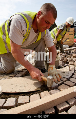 Modern cobblestone being laid Stock Photo