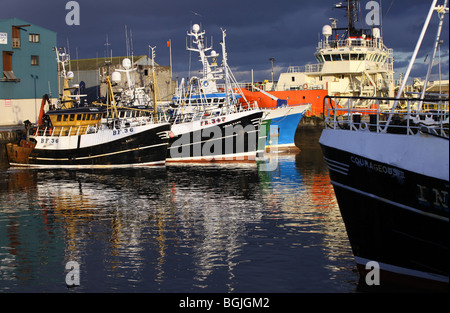 North Sea fishing trawlers berthed in Fraserburgh Harbour, Aberdeenshire, Scotland, UK, at sunset Stock Photo