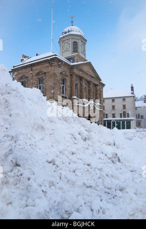 Kelso Scotland in winter snow - huge pile of snow cleared from town centre roads hides the town hall Stock Photo