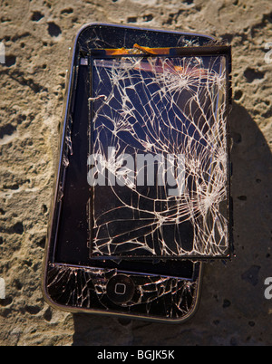 ARLINGTON, VIRGINIA, USA - Damaged Apple iPhone 3G smart phone, with shattered screen. Stock Photo