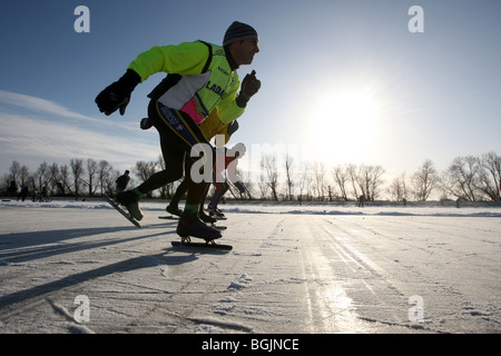 Skaters on a frozen flooded field in Upware, Cambridgeshire. The ...