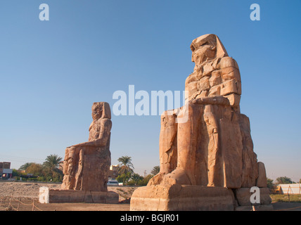 The Colossi of Memnon close to the Valley of of the Kings on the West Bank of the River Nile in Egypt Stock Photo