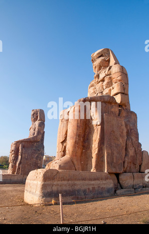 The Colossi of Memnon close to the Valley of of the Kings on the West Bank of the River Nile in Egypt Stock Photo