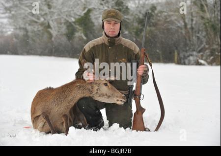 deer stalker with his shot red deer Stock Photo