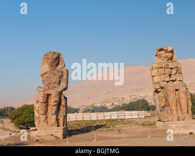 The Colossi of Memnon close to the Valley of of the Kings on the West Bank of the River Nile in Egypt Stock Photo