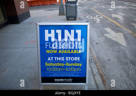 A sign saying H1N1 flu shots available outside a pharmacy in the Brooklyn neighborhood of Williamsburg in New York Stock Photo