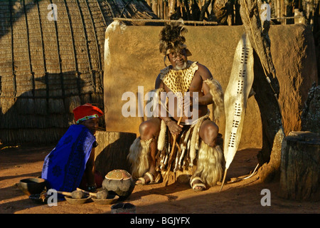 Zulu chief and woman in village compound, Shakaland, South Africa