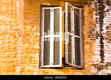 Window with slatted shutters in 19th or early 20th century apartment building in centre of Malaga, Malaga Province, Spain Stock Photo