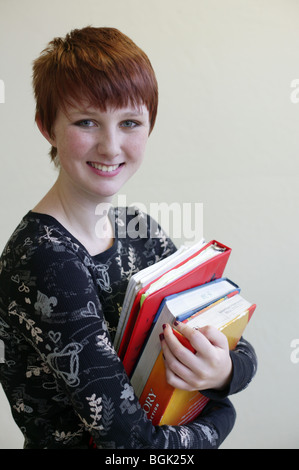 Portrait of student holding books Stock Photo - Alamy