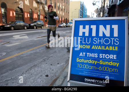 A sign saying H1N1 flu shots available outside a pharmacy in the Brooklyn neighborhood of Williamsburg in New York Stock Photo