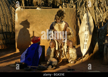 Zulu chief and woman in village compound, Shakaland, South Africa