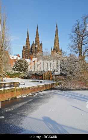 Three spires Cathedral Garden of Remembrance and Minster Pool on snowy winter’s day 2010 Lichfield Staffordshire England Stock Photo