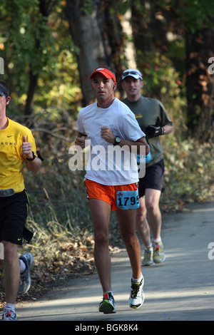 Marathon running race. Legs and bodies only. Unrecognizable people. The