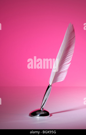 Quill pen isolated on purple background Stock Photo