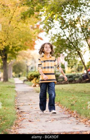 boy walking on pathway Stock Photo