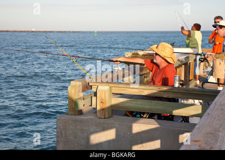 Cape Canaveral, FL - Nov 2008 - Handicapped man fishing from wheelchair on fishing pier at Jetty Park in Cape Canaveral, Florida Stock Photo