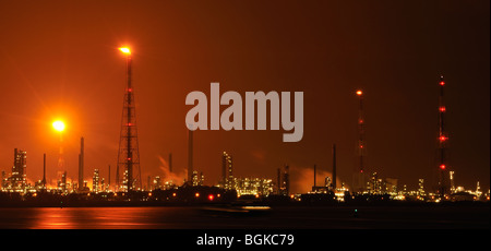 Burning gas flames of petrochemical industry at night in the Antwerp harbour, Belgium Stock Photo