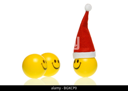 Smiley with Santa hat in front of two smileys Stock Photo