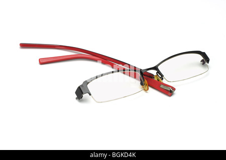 Broken pair of spectacles on white background Stock Photo