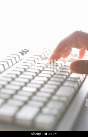 Person typing on keyboard Stock Photo