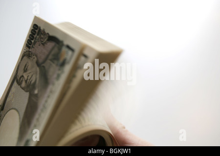 Hand counting Japanese yen Stock Photo
