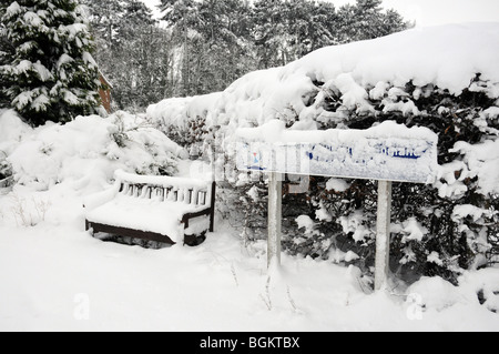 The sign at a closed school with a bench.  Closed due to snow. Stock Photo