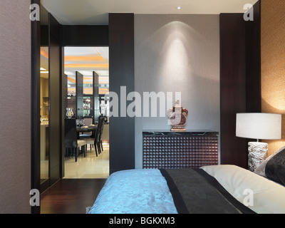 Bed and doorway in modern bedroom Stock Photo