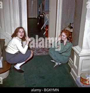 NEW JERSEY, U.S.A. - Teenage Girls on Telephone at Home, in the 1950's., Old Family Photo Archives, teens talking on phone, vintage American photos, Surprised Stock Photo