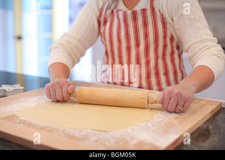 Rolling dough with rolling pin Stock Photo