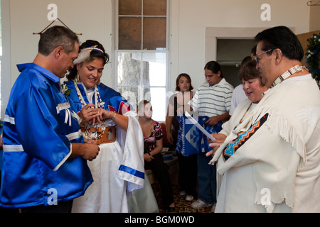 Native American bride and groom exchange rings during wedding ceremony inside Williamson River Indian Mission church, Chiloquin Oregon Stock Photo