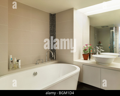 Light colored modern bathroom with large bathtub Stock Photo