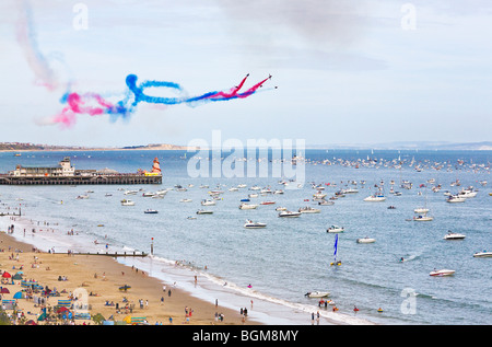The Red Arrows display team performing their routine over the pier at the Bournemouth Air Festival. Dorset. UK.
