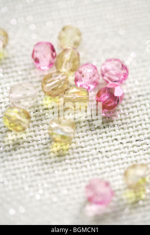 Coloured beads on shiny white textile Stock Photo