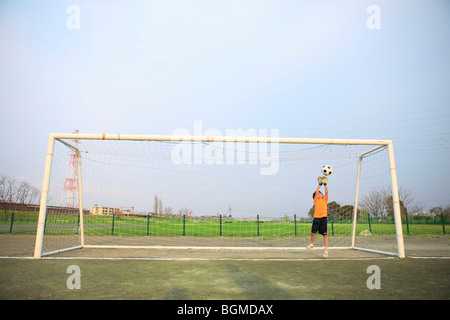 Young boy goalkeeping on field. Futako-tamagawa Setagaya-ku Tokyo Prefecture Japan Stock Photo