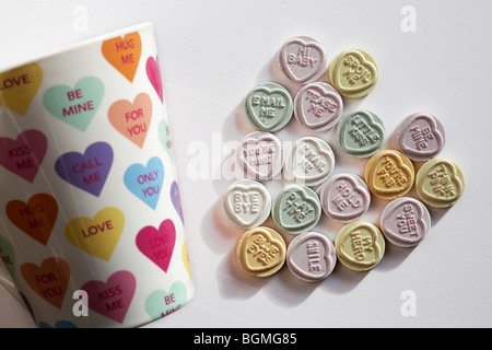 Sweetheart sweet heart - Love heart sweets with messages, arranged in a heart shape together with love hearts mug for Valentines day, Valentine day Stock Photo