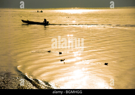 Boat and birds on the sparkling sea. Oarai, Oarai-machi, Ibaraki Prefecture, Japan Stock Photo