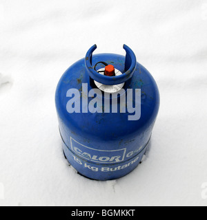 Calor Gas company Butane gas cylinder bottle standing in snow Stock Photo