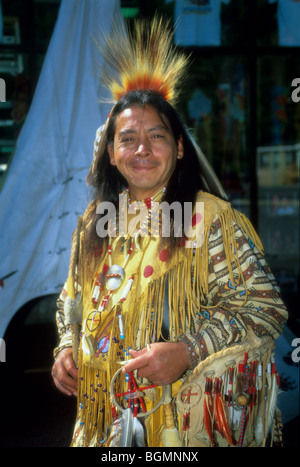 Native American medicine man dressed in ghost shirt shakes wooden staff ...