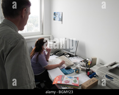 Manager supervises employee in the office Stock Photo