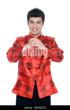 Young man in Chinese traditional clothes giving best wishes Stock Photo