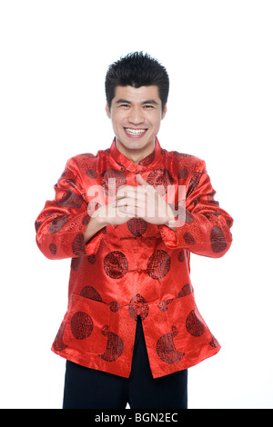 Young man in Chinese traditional clothes giving best wishes Stock Photo