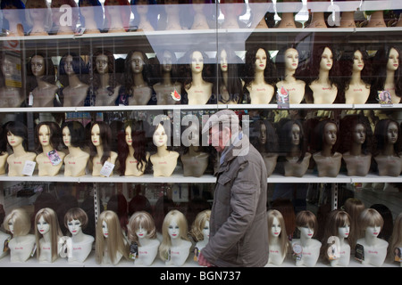 Variety of skin colours and ethnicity on wig model heads in high-street fashion shop window. Stock Photo