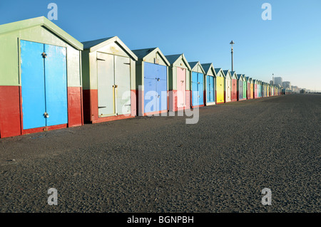 Colourful painted beach huts on the seafront at Brighton and Hove. Stock Photo