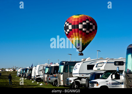 Hot air Balloon floating low over RV's at 'The Rally'. Albuquerque, New Mexico, USA