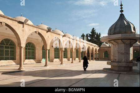 A woman walks through the Dergah complex of Mosques, Urfa, Turkey Stock Photo