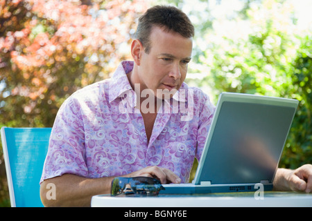 Mature man using a laptop Stock Photo