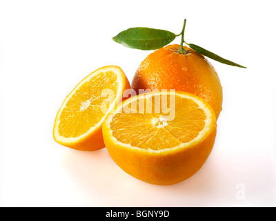 Fresh whole and cut oranges with leaves  on a white background as a cut out Stock Photo