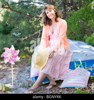 Portrait of a mature woman sitting on the bed in a garden Stock Photo